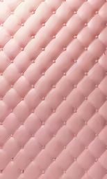 a pink quilted upholstered object on the floor
