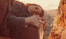 there is a woman standing next to a man holding her hand