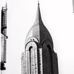 a tall building has a steeple with a clock