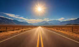 the sun shines brightly on an open desert road