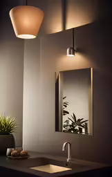 a bathroom sink sitting under a vanity light