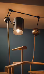 the light fixture on a lamp is next to a chair
