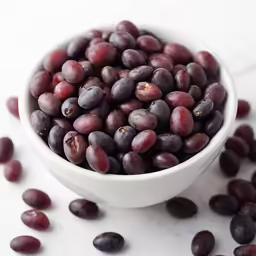 the grapes are sitting in a bowl on the table