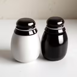 the black and white salt and pepper shakers are both round