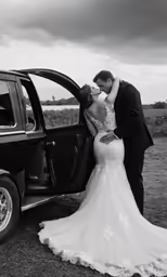 the bride and groom kiss near a red truck