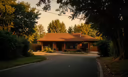 a road going through the house next to some trees