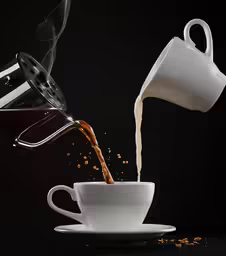 coffee being poured into a white cup