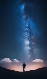 a man standing on top of a dirt field under the stars