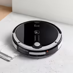 a small robotic vacuum is on a white counter top