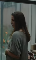 a woman standing with her back against a wall