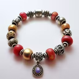 there is an image of a bracelet made of different beads,the bracelet has beads and charms in it