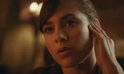 a woman with her hand on her head