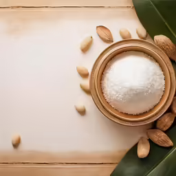 nuts scattered around a bowl of white sugar