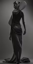 a woman in black dress and hat standing