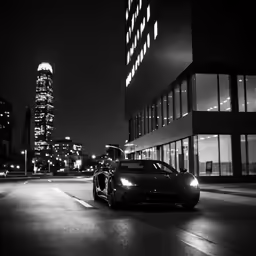 a sports car on a street in front of tall buildings