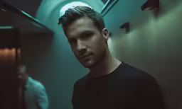 man in black shirt looking at camera and other person in white shirt