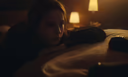a girl that is laying down on a bed