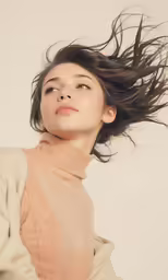 a woman with long brown hair in the wind