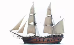 an old fashioned ship in the water