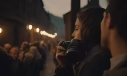 a woman holds a camera while taking a picture
