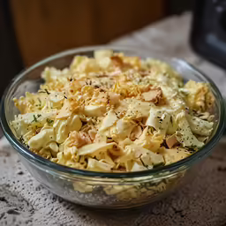 a bowl filled with cooked noodles and parsley