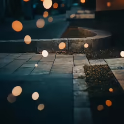 small boke on a walkway on a street corner at night