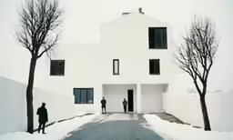 two people stand at the entrance to a house that has been constructed out of snow