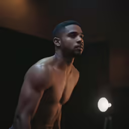 a young black man in shorts looking at the camera