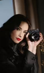 a woman in a black coat taking a photograph