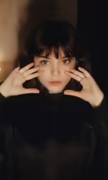a woman with a black coat and one hand on the back