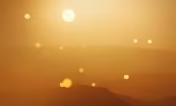 the sun is shining brightly on a desert landscape