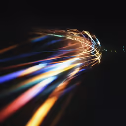 an extremely long exposure photograph shows multi colored lights