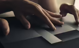 a hand on top of a piece of paper