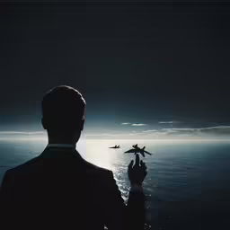 a man in a suit standing next to an airplane