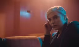 a person sitting on a couch, wearing a tie