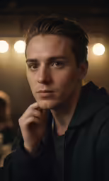 young man sitting in a bar posing for a photograph