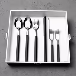 a tray with fork, spoons, and a knife