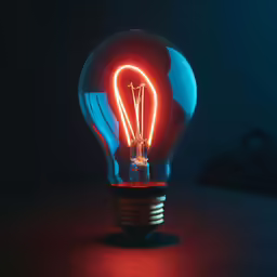 a blue light bulb sitting in the dark