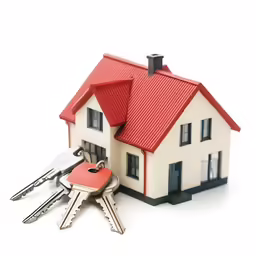 a small model house next to bunch of keys