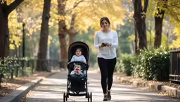 a woman walking with a baby in a stroller