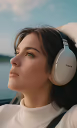 a woman looking ahead while wearing headphones