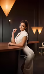 the woman in white poses for the photo in her office