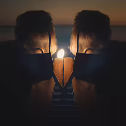 the image has two people looking out at something and a light coming out of their hands