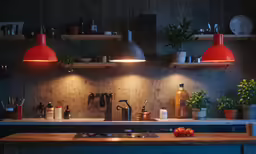 the light on in the kitchen has many red lamps over it