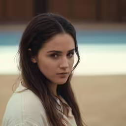 a girl with long hair is wearing a white shirt