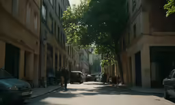 people are walking down the alleyway near buildings