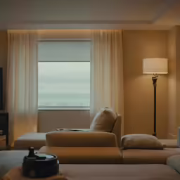 a large beige couch and two lamps in a living room