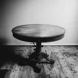 an old table sits against a white wall