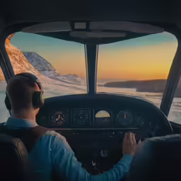 man sits in the cockpit of an airplane