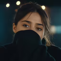 a woman covering her face with her hands